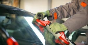 a person is polishing the windscreen of the car