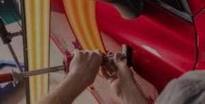 a person is repairing the door of the car