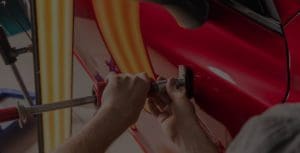 a person is repairing the handle of the car