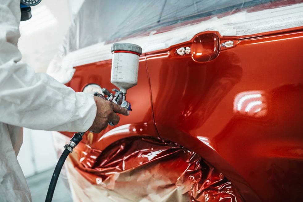 a professional is painting the car